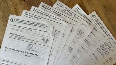 Med-Cal renewal documents spread out on a table.