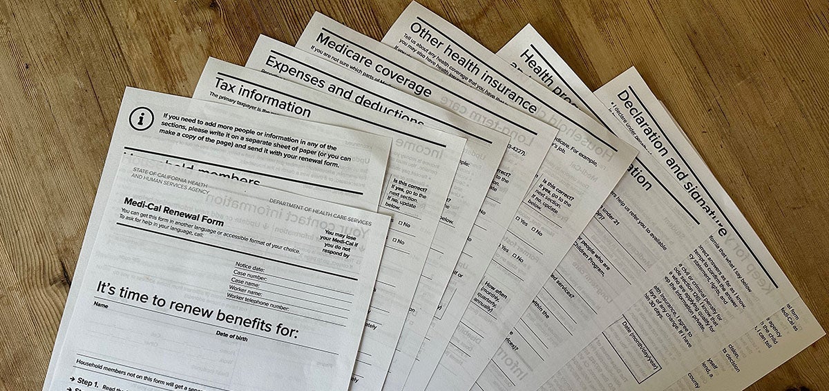 Med-Cal renewal documents spread out on a table.