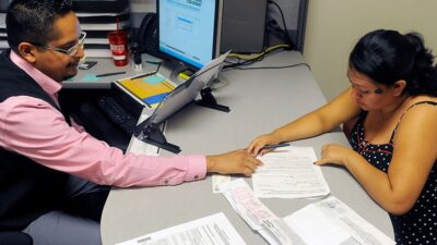 Enrollment Specialist Horacio Castaneda, left, helps Rosa Ayala Cruz, right, apply for health benefits at the Denver Health Westside Family Health Center on October 01, 2013 in Denver, Colorado. Key provisions of the Affordable Care Act's health insurance marketplaces are set to go into effect today. It's been reported that some consumers have experienced technical problems with the website sign-up that is believed to be caused by higher-than-expected volume. (Photo by Chris Schneider/Getty Images)