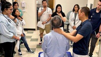 Medical students at UC Davis receiving instruction on how to perform a physical exam.