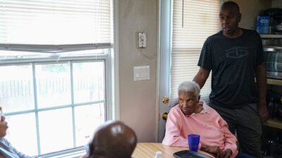 Family sits at kitchen table