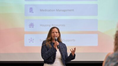 Stacey Berardino, assistant deputy director over the forensics and justice involved division of mental health, speaks to community members about CARE Court