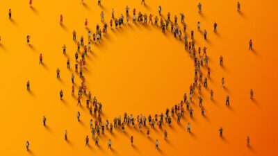 Illustration of a large group of people standing in the shape of a speech bubble.