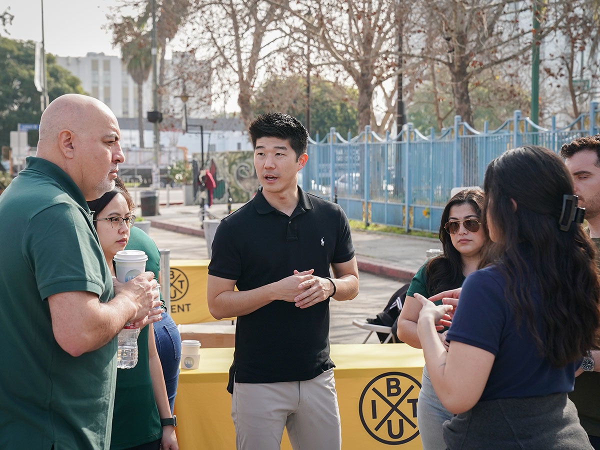 Pear Suite CEO Colby Takeda, center, working with his team before their event at Leimert Park.