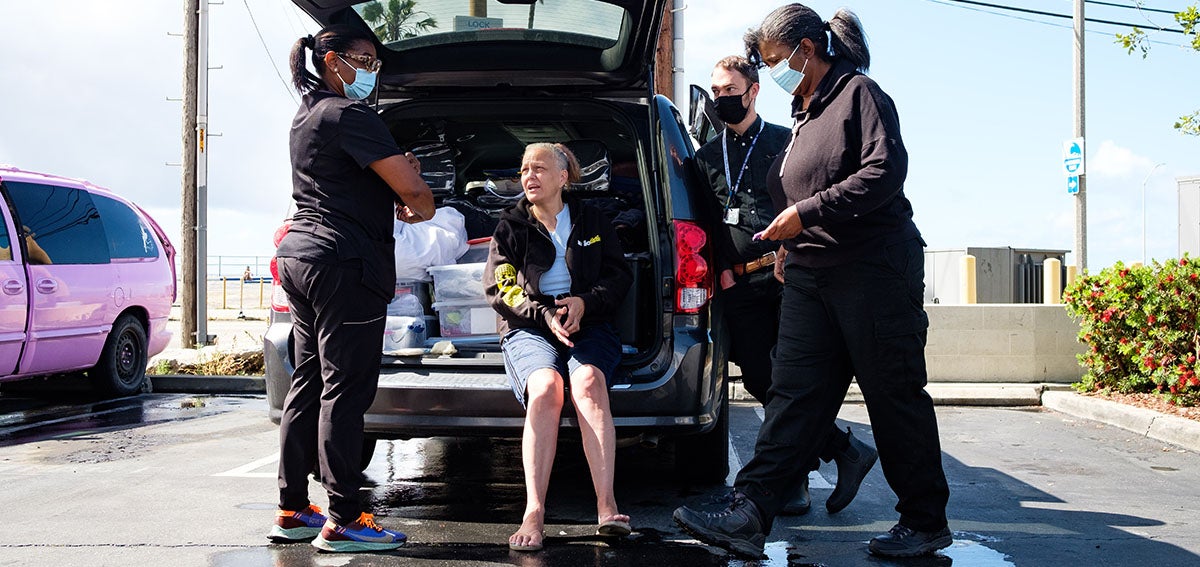 Woman experiencing homelessness receives care from a street medicine team.