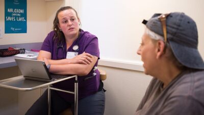 Patient and provider talk during clinic visit.