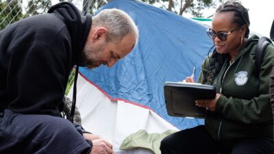 Street medicine practitioner assesses client's injury