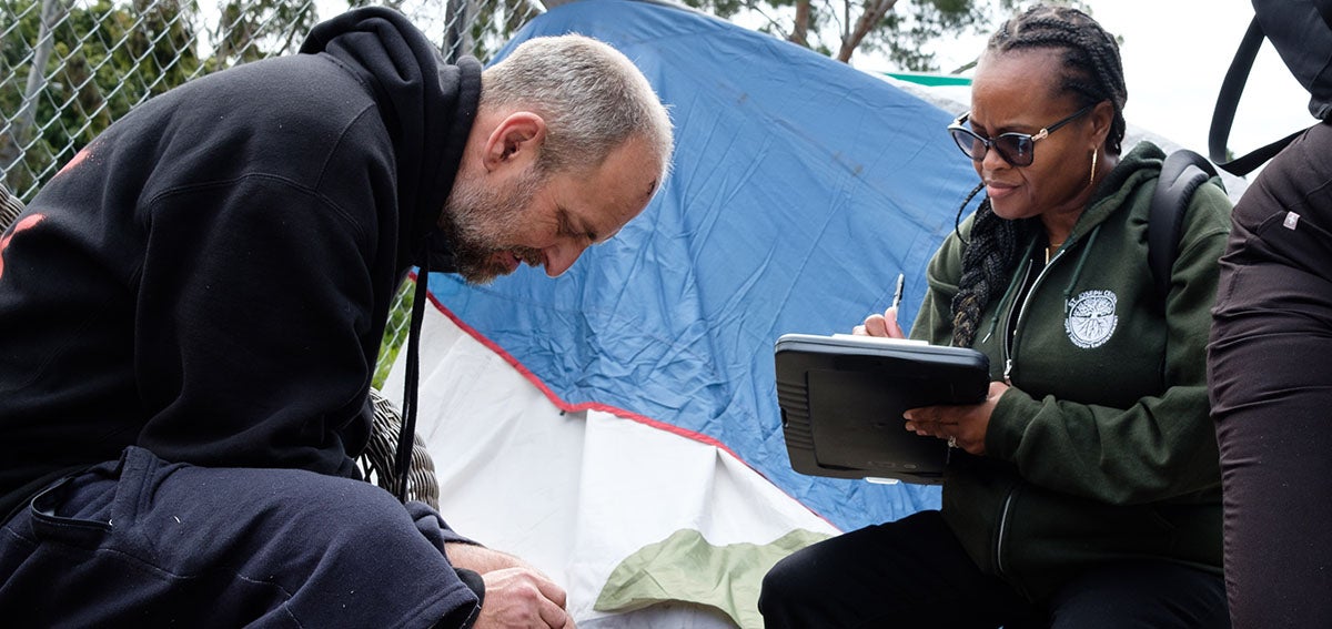 Street medicine practitioner assesses client's injury