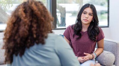 Two women having a discussion in a counseling session.