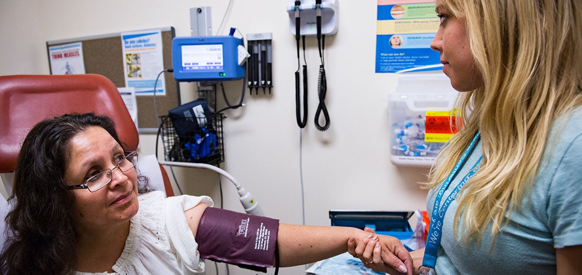 Physician Assistant taking patient's blood pressure.