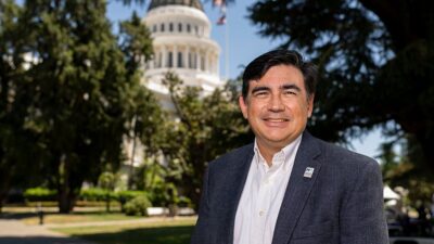 Anthony Wright stands in front of the California State Capitol Building