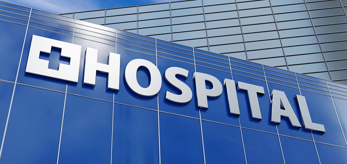 Glass building with "Hospital" sign
