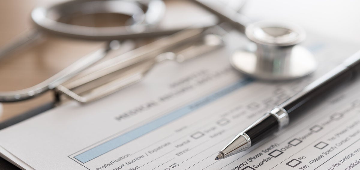 medical form with pen and stethoscope sitting on top of it