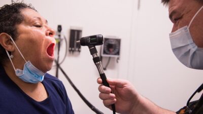 Patien having mouth examined by provider in a clinic.