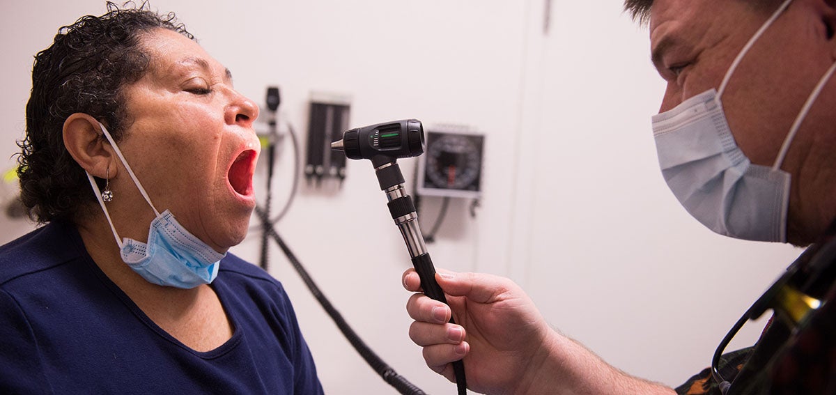 Patien having mouth examined by provider in a clinic.