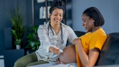 Patient at office visit with midwife.