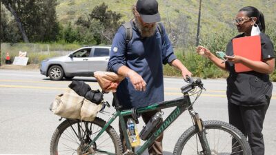 Medical practitioner reaches out to person experiencing homelesness.