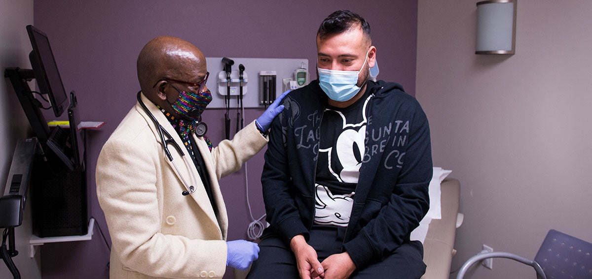 Doctor talks to patient in clinic