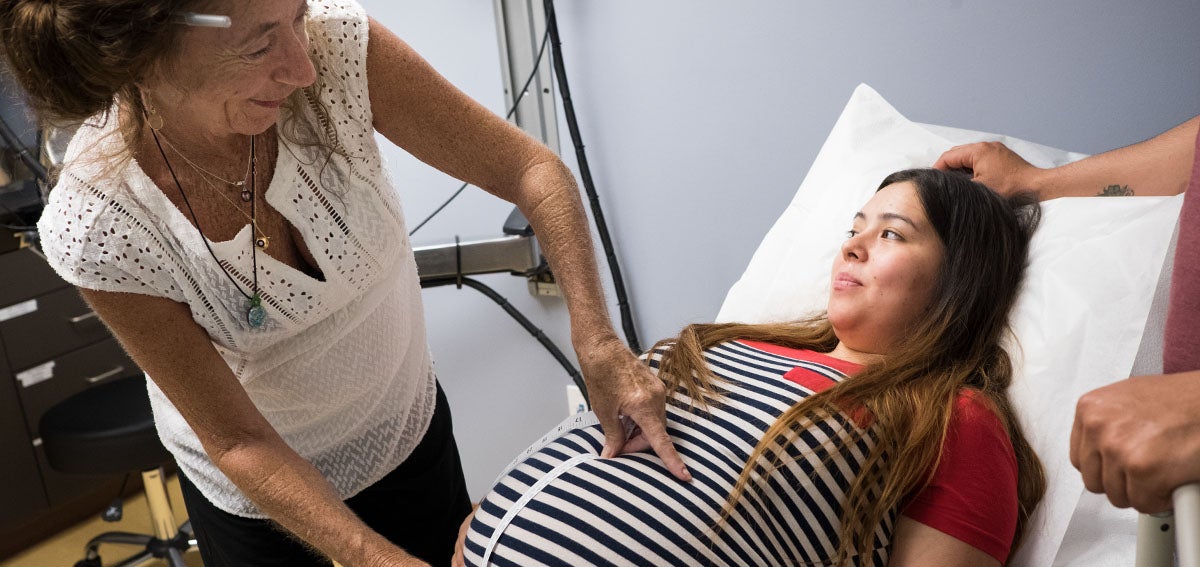 Doctor measures pregnant patient