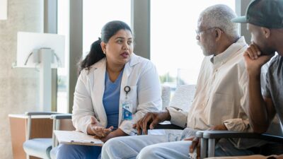 Doctor talks to patient and family member
