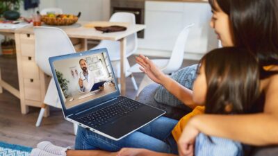 Mother and daughter talking to doctor on a telehealth visit