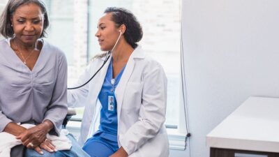 Doctor listens to patient's breathing.