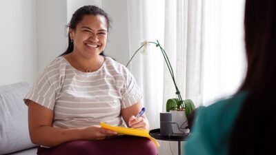 Community health worker talks to client.