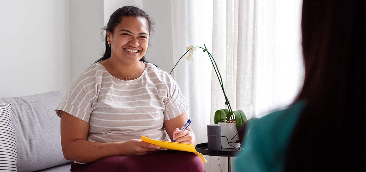 Community health worker talks to client.
