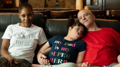 Mother daughter and father sitting on a couch