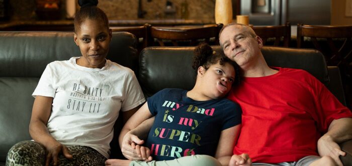 Mother daughter and father sitting on a couch