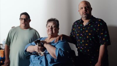 Elaine Berg lives in Bakersfield with her son Alpha Omega "Poppy" Stewart, right, who has Down syndrome. Both are Medi-Cal enrollees. Stewart's friend since high school, Daniel Montes, is at left.