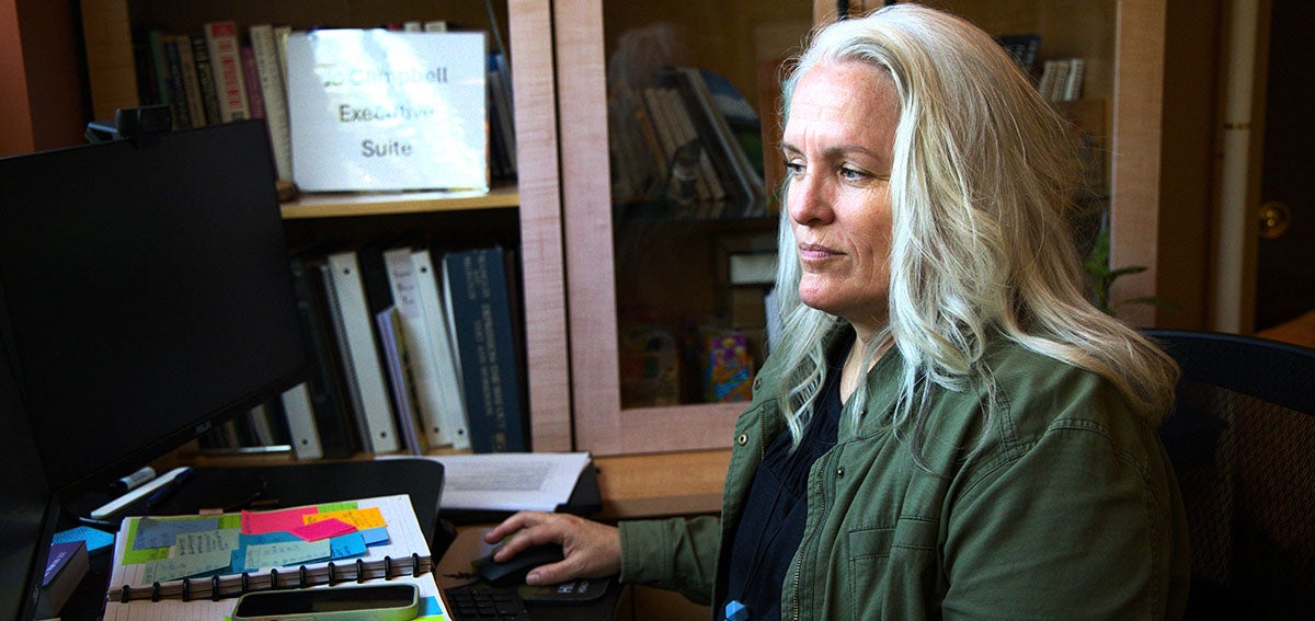 Woman working at a computer in an office.