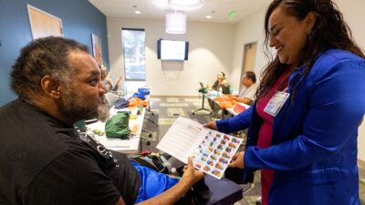 behavioral health data reforms - Case manager leads wellness group meeting