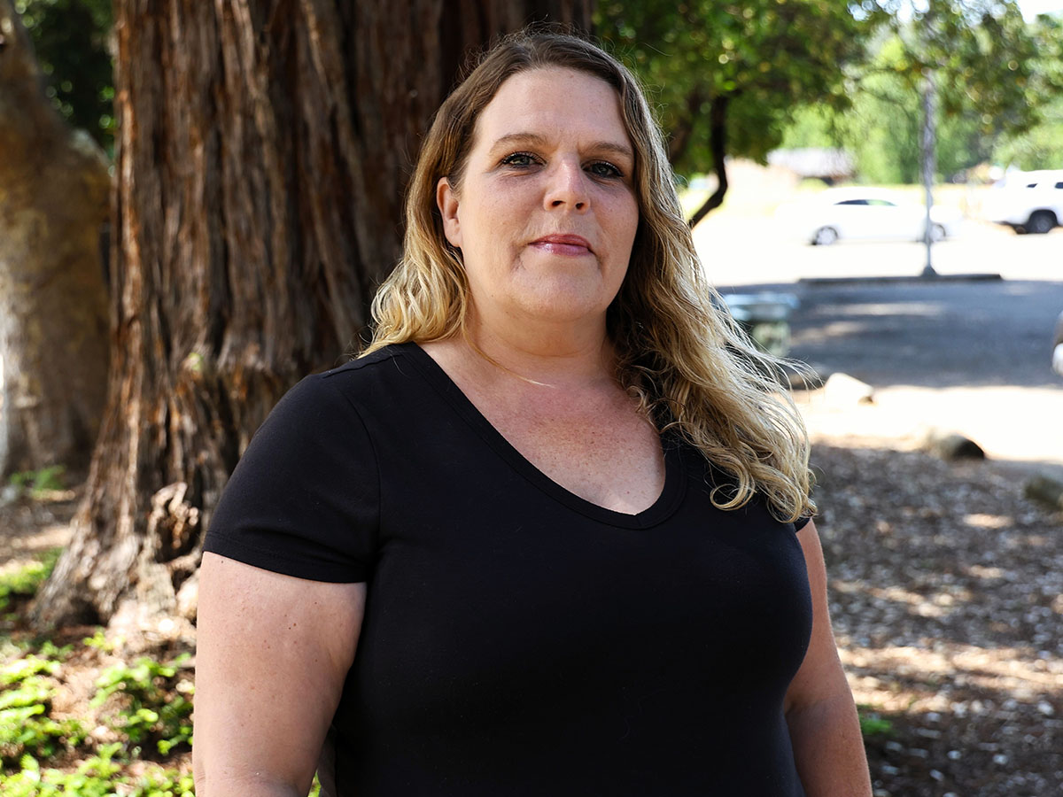 Federal Medi-Cal cuts - Melissa Hamilton stands near a tree