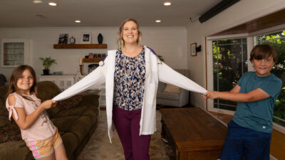 Tiffany Damikolas and family play together in their living room.