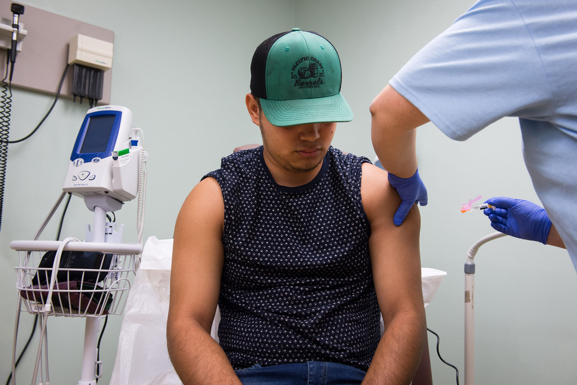 60 years of Medicaid - Young man getting an injection at a doctor's office.