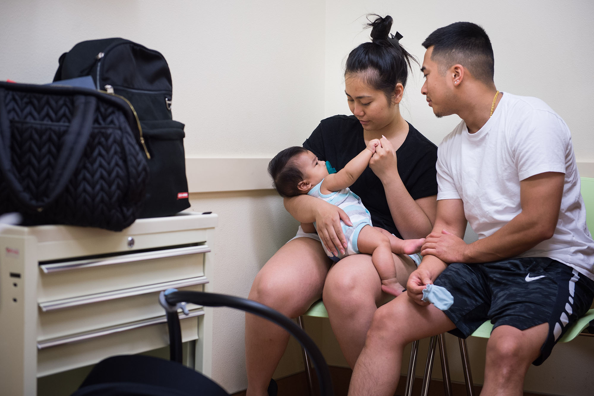 60 years of Medicaid - Mother and father with baby at a doctor's office