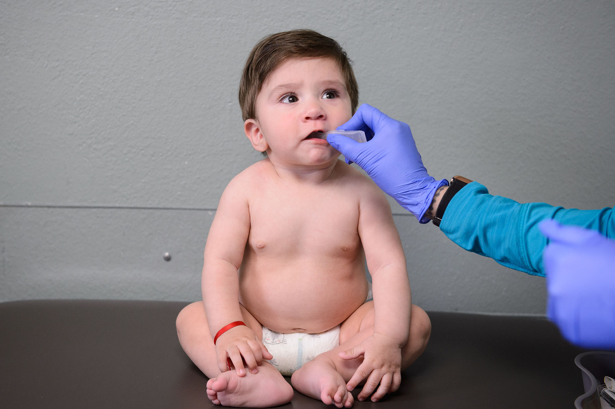 60 years of Medicaid - Baby getting a dose of medication at a doctor's office