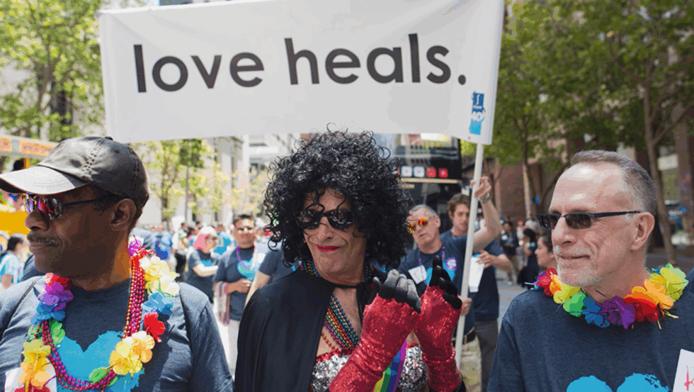 Three LGBTQ elders march in a Pride parade.