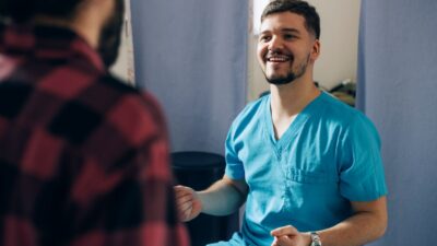 Clinician talking to male patient