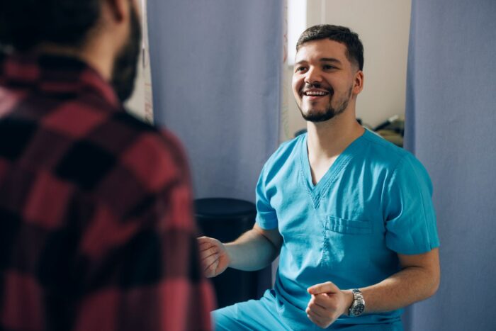 Clinician talking to male patient