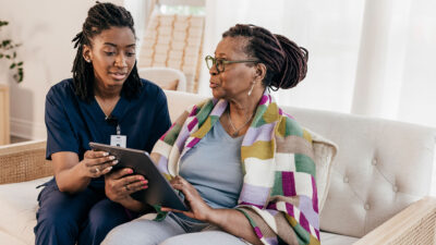Home health care worker with client