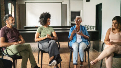 Four people participate in a group discussion.