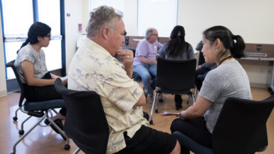 Program administrator talking to a patient at a clinic