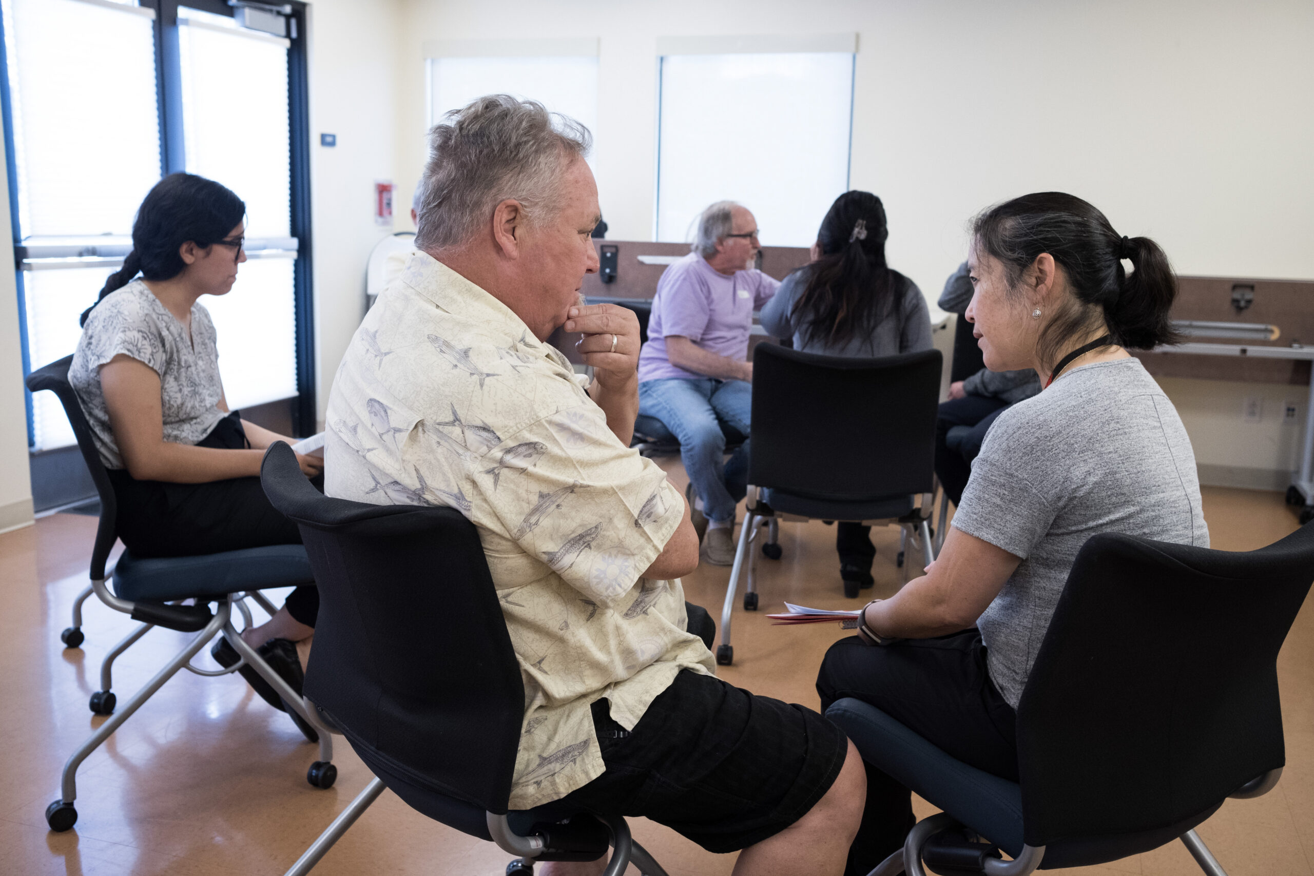Program administrator talking to a patient at a clinic