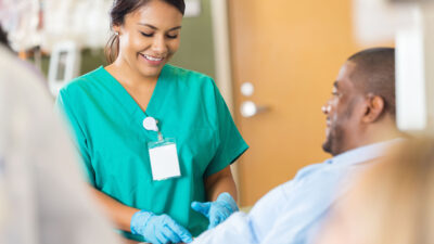 Nurse working with patient in clinic.