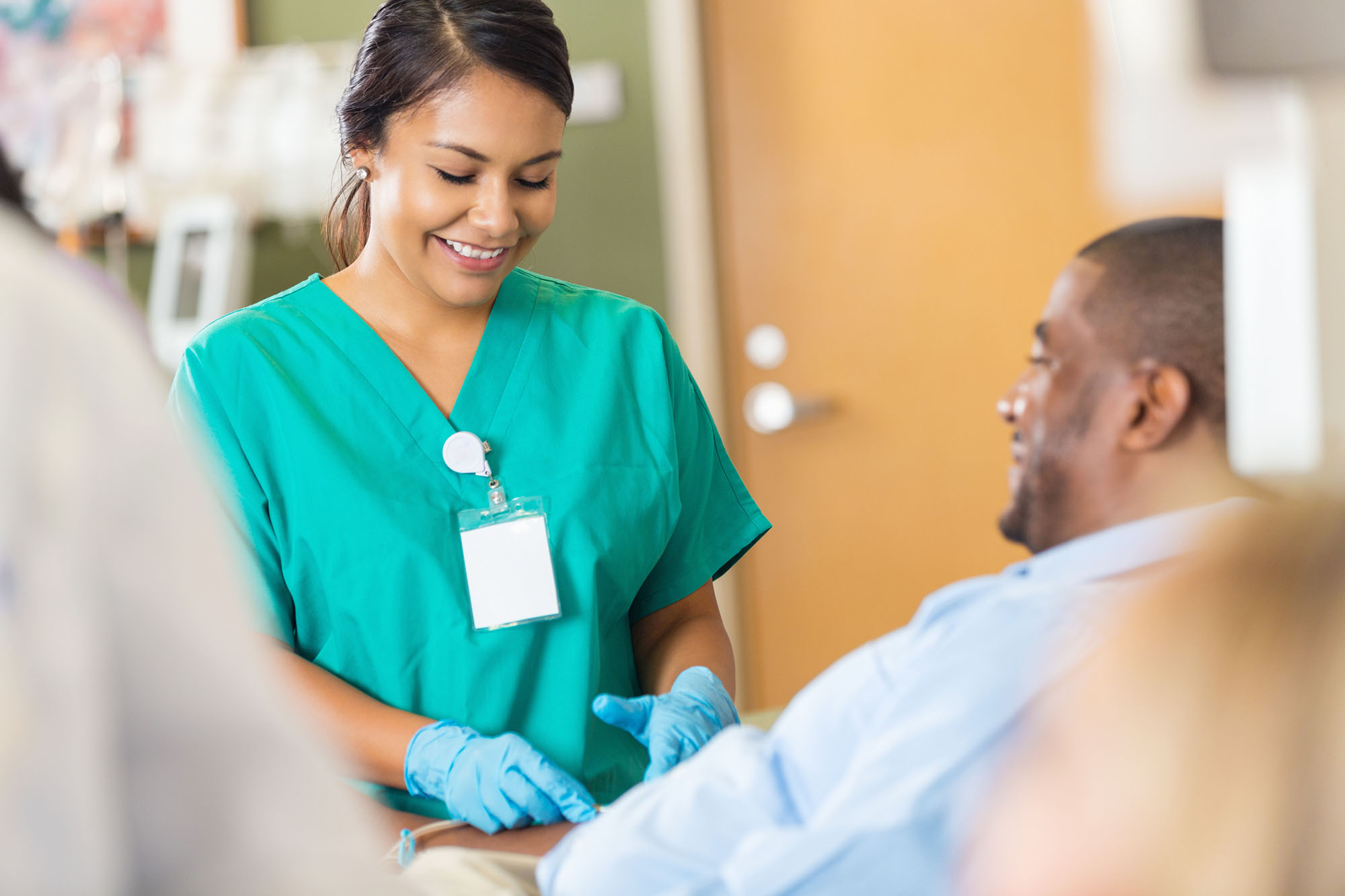 Nurse working with patient in clinic.