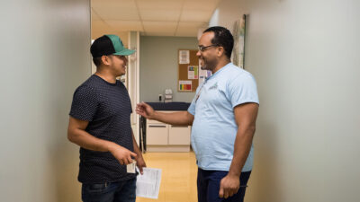 Doctor and patient have a freindly conversation in a clinic.