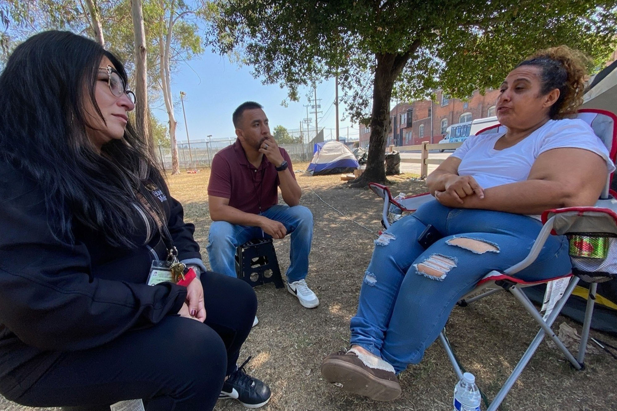 Lisette Carmona, LCSW, Social Work Manager, Clinical Instructor of Family Medicine, Keck School of Medicine of USC alongside Raymond Gonzales, Case Worker at USC Street Medicine speak with patient receiving behavioral health care treatment.