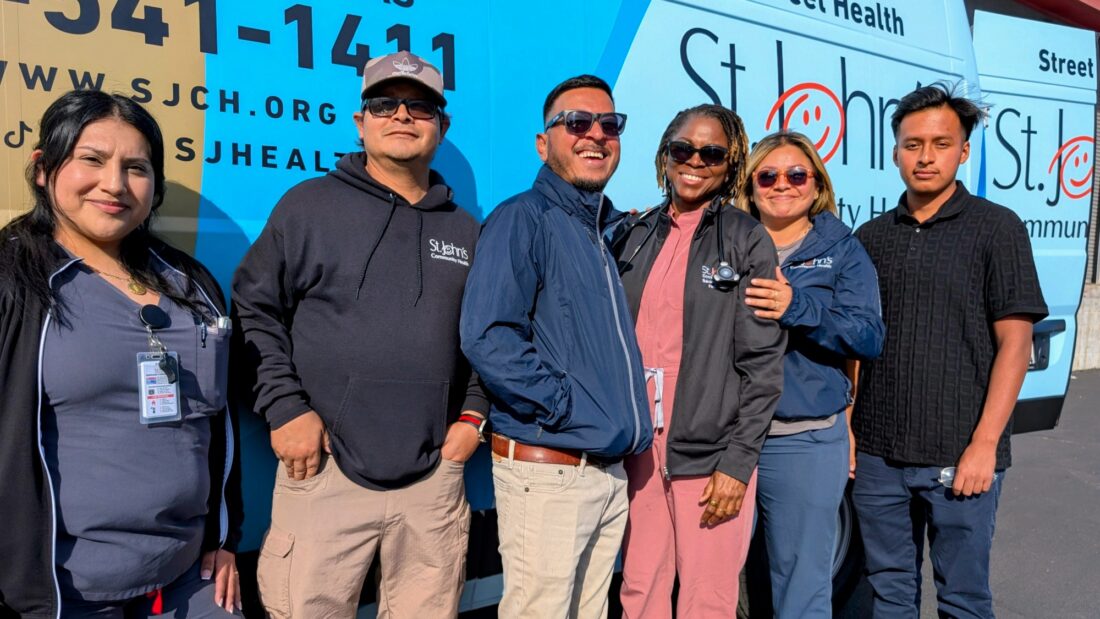 Los Angeles community clinic tax measure -  street medicine team members next to their van